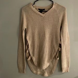 Tan knit sweater with three cut outs on the sides